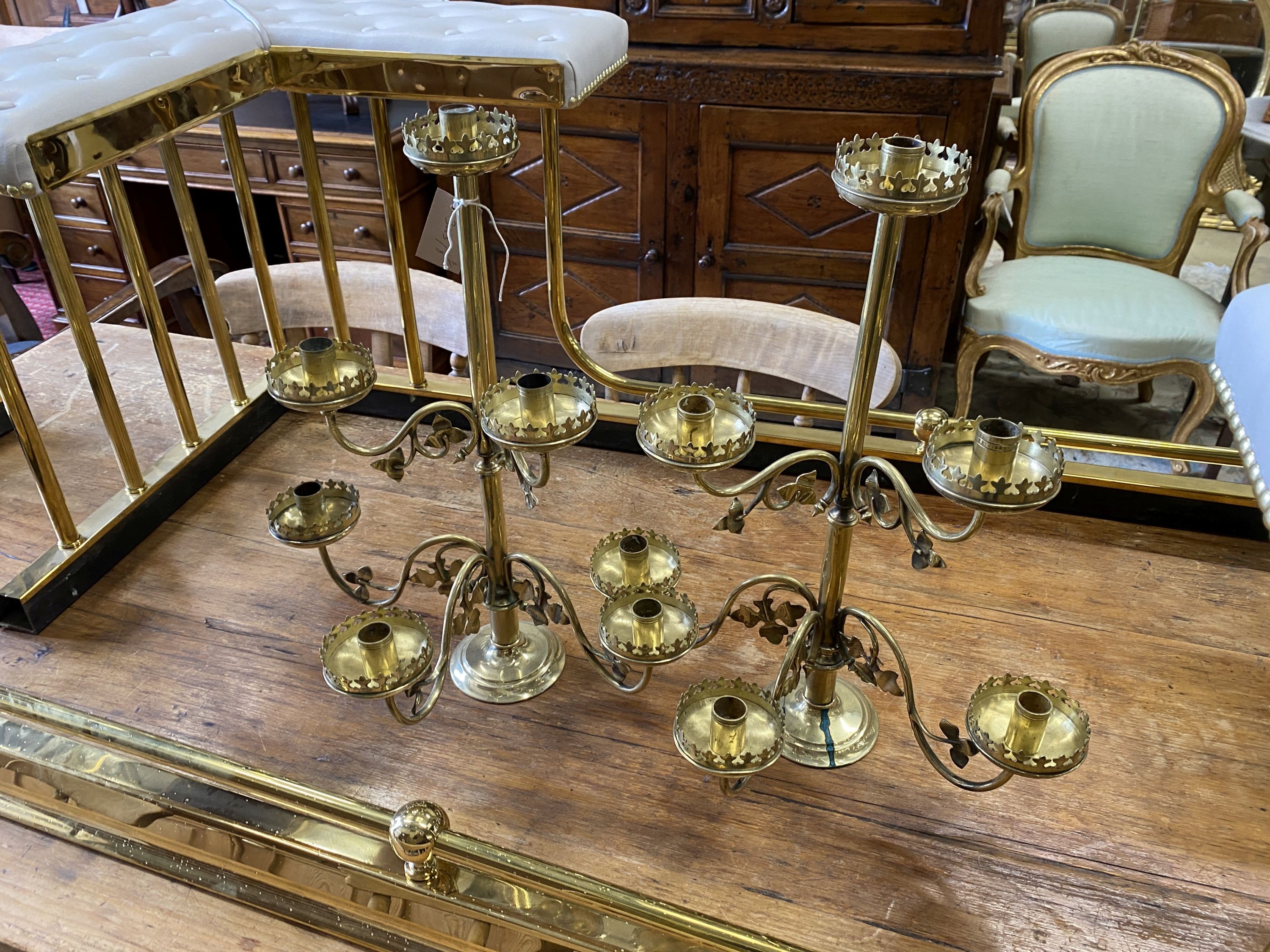 A pair of Victorian brass six branch candlesticks, height 52cm